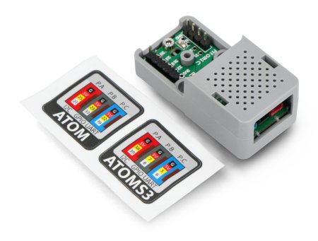 The unit m5stack expansion module in gray lies on a white background along with pin map stickers.