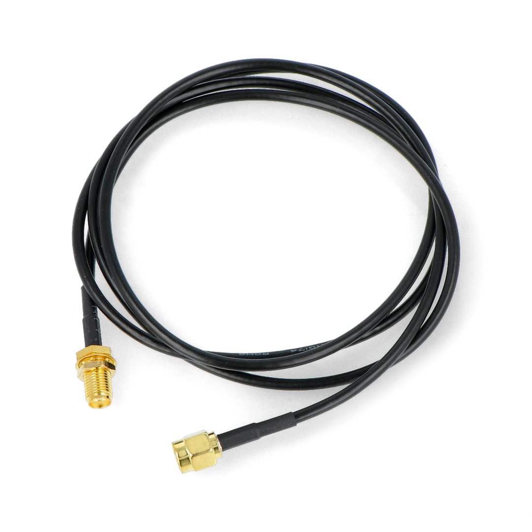 A coiled SMA antenna cable lies on a white background.