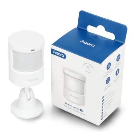A white motion and light sensor stands on a white background next to the box.