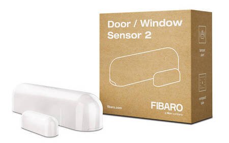 The white Fibaro door and window opening sensor lies on a white background with a box.